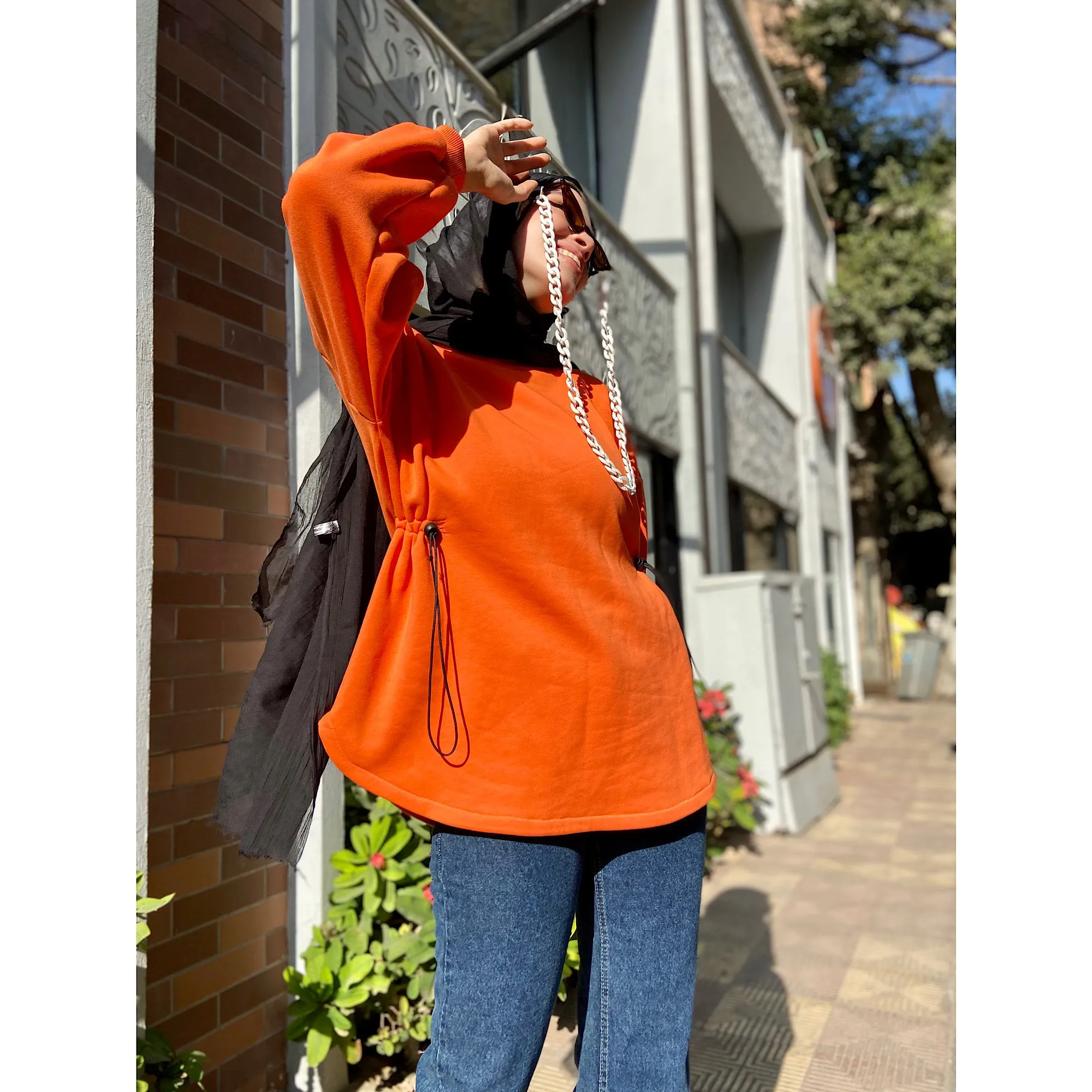 Bright orange drawstring sweater